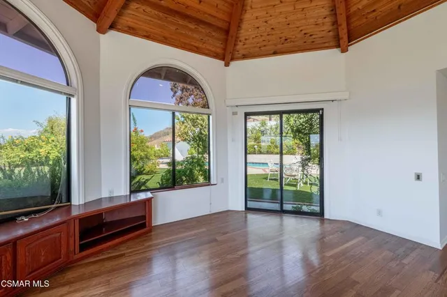 a view of an entryway with wooden floor and garden