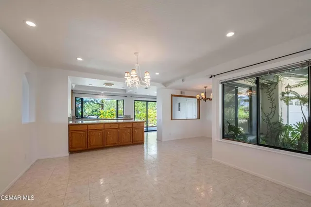 a large room with a large window and chandelier