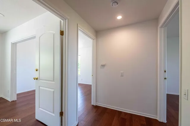 a view of hallway with wooden floor