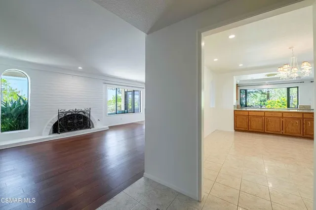 a view of a livingroom with wooden floor and windows