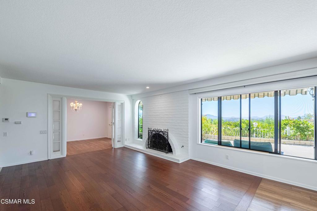 1319 Wilder Street Thousand Oaks, CA 91362 - Photo 5 of 31 an empty room with wooden floor and a fireplace