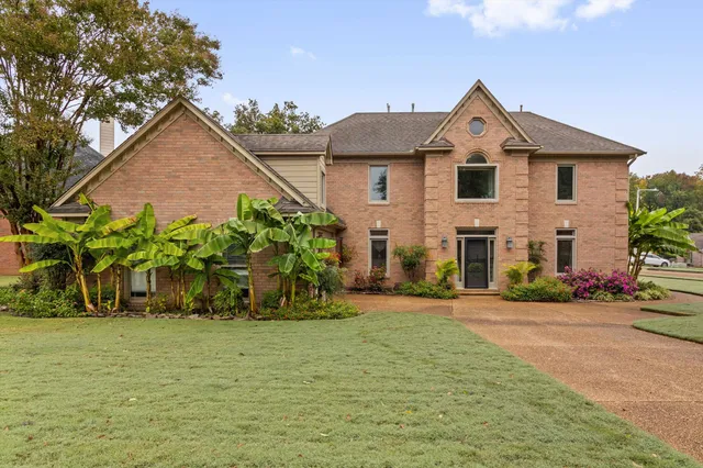 a front view of a house with a yard