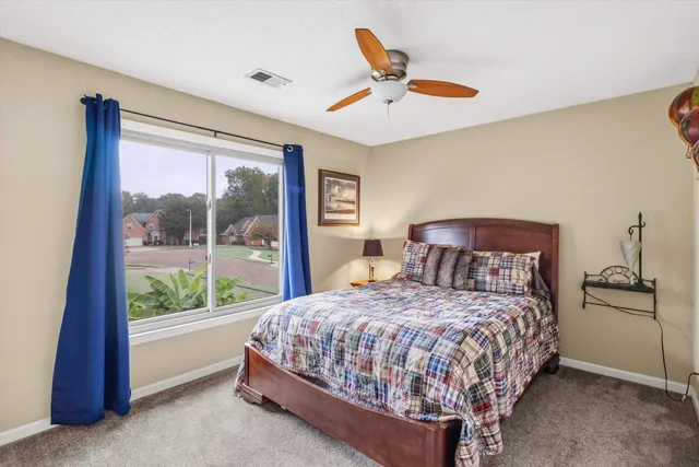 a bedroom with a large bed and a large window