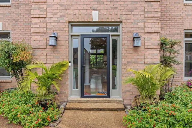 a front view of a house with a garden