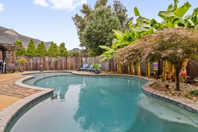 a view of a swimming pool with a patio