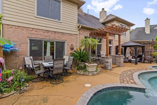 a view of a patio with dining table and chairs with plants