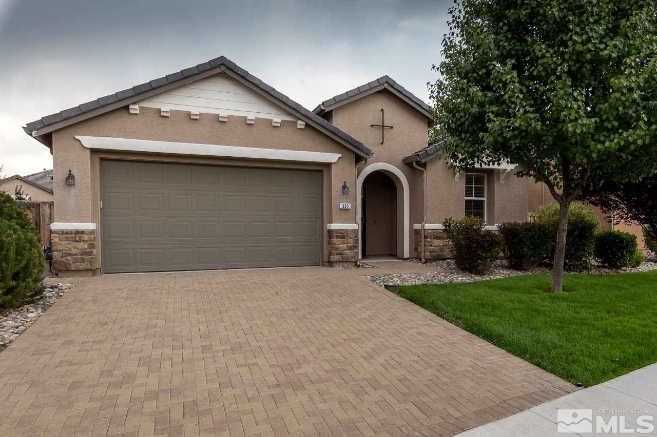 330 Teramo Drive Reno, NV 89521 - Photo 4 of 24 a front view of a house with a yard and garage