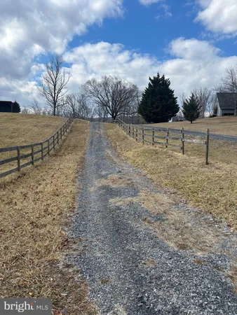 a view of a yard with wooden fence