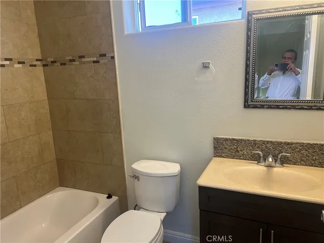 a bathroom with a sink a mirror and a toilet