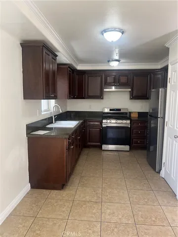 a kitchen with stainless steel appliances granite countertop a sink counter space and cabinets