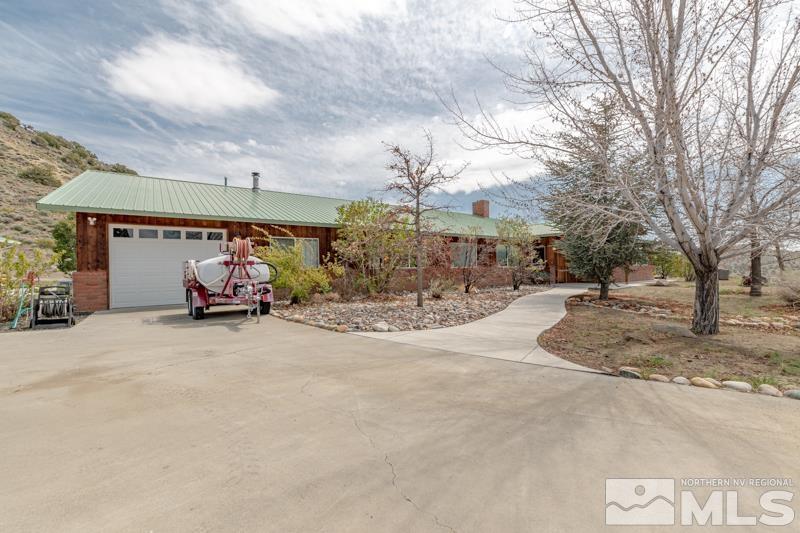 14045 North Red Rock Road Reno, NV 89508 - Photo 1 of 40 a view of a house with snow and a garage