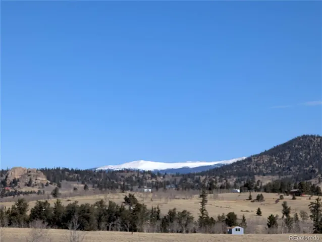 a view of a large mountain with mountains in the background