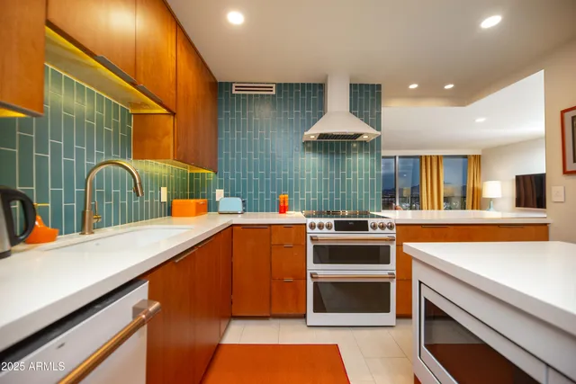 a bedroom with a bed and large windows