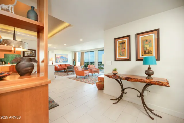a living room with furniture a flat screen tv and a floor to ceiling window