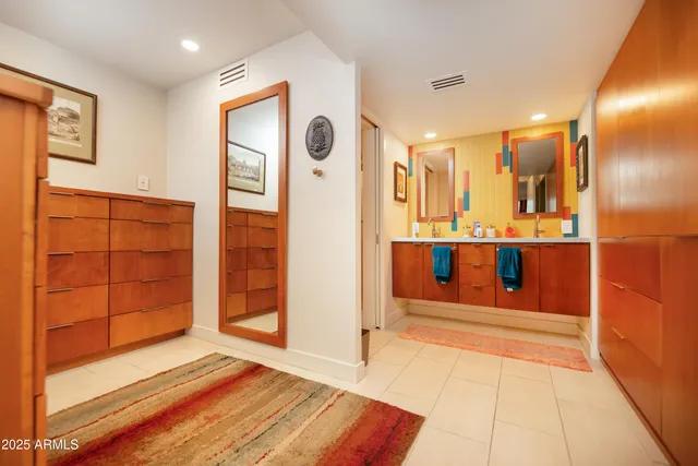 a view of a patio with table and chairs potted plants and a palm tree
