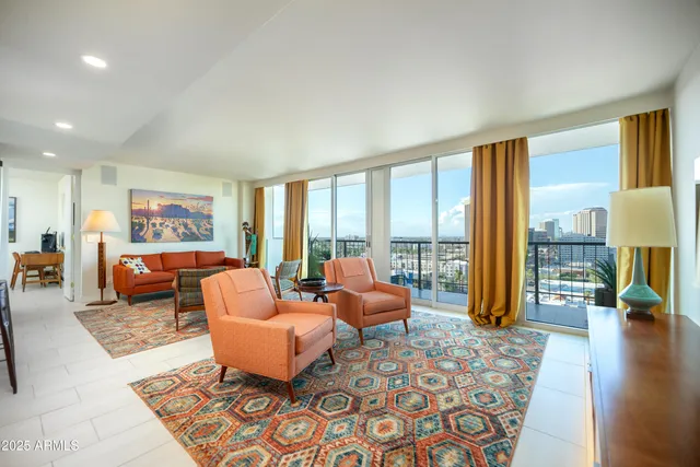 a kitchen with stainless steel appliances kitchen island granite countertop a stove a sink and a refrigerator