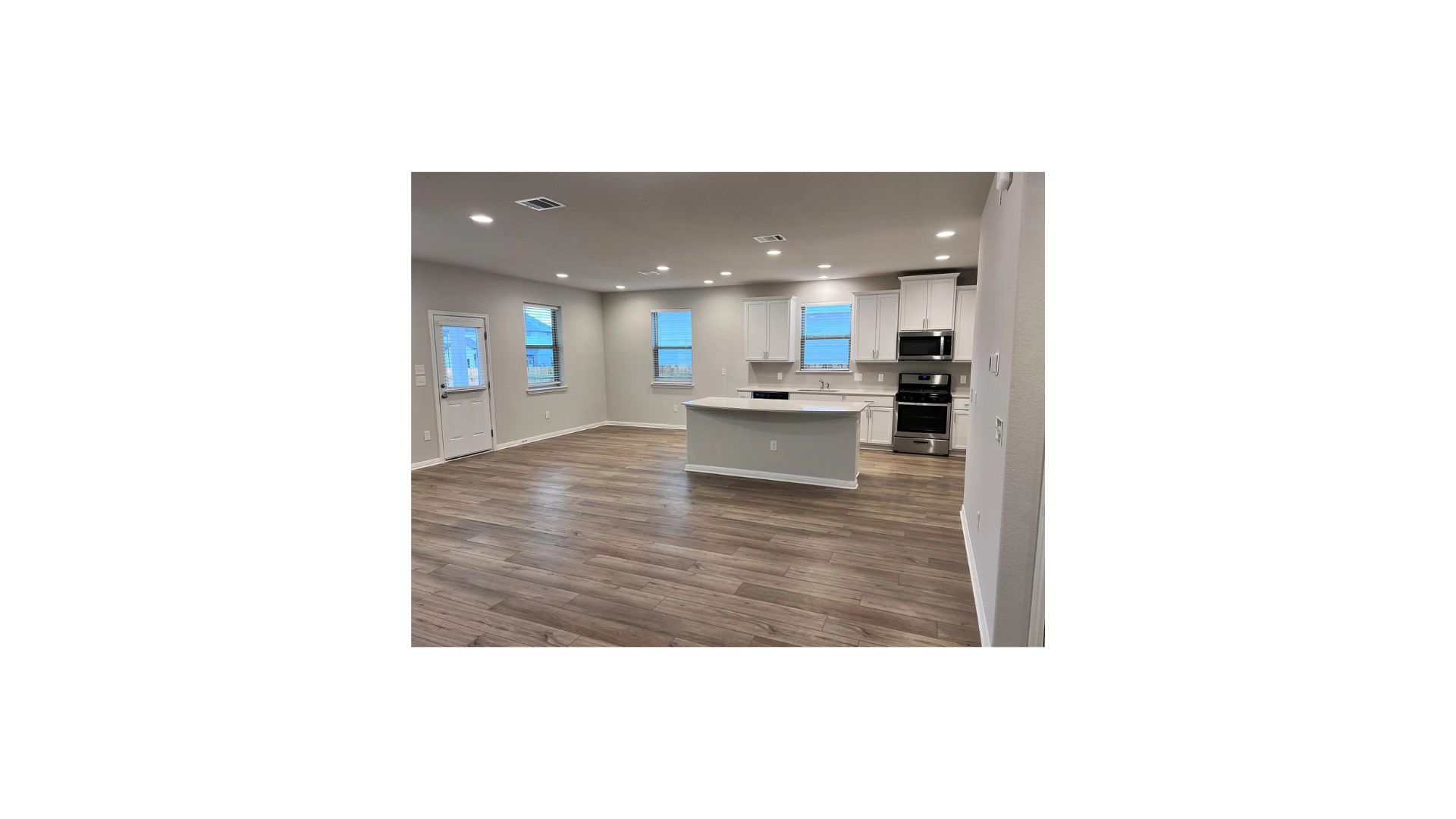 320 Rend Drive Leander, TX 78641 - Photo 2 of 11 a view of living room with kitchen island stainless steel appliances wooden floor