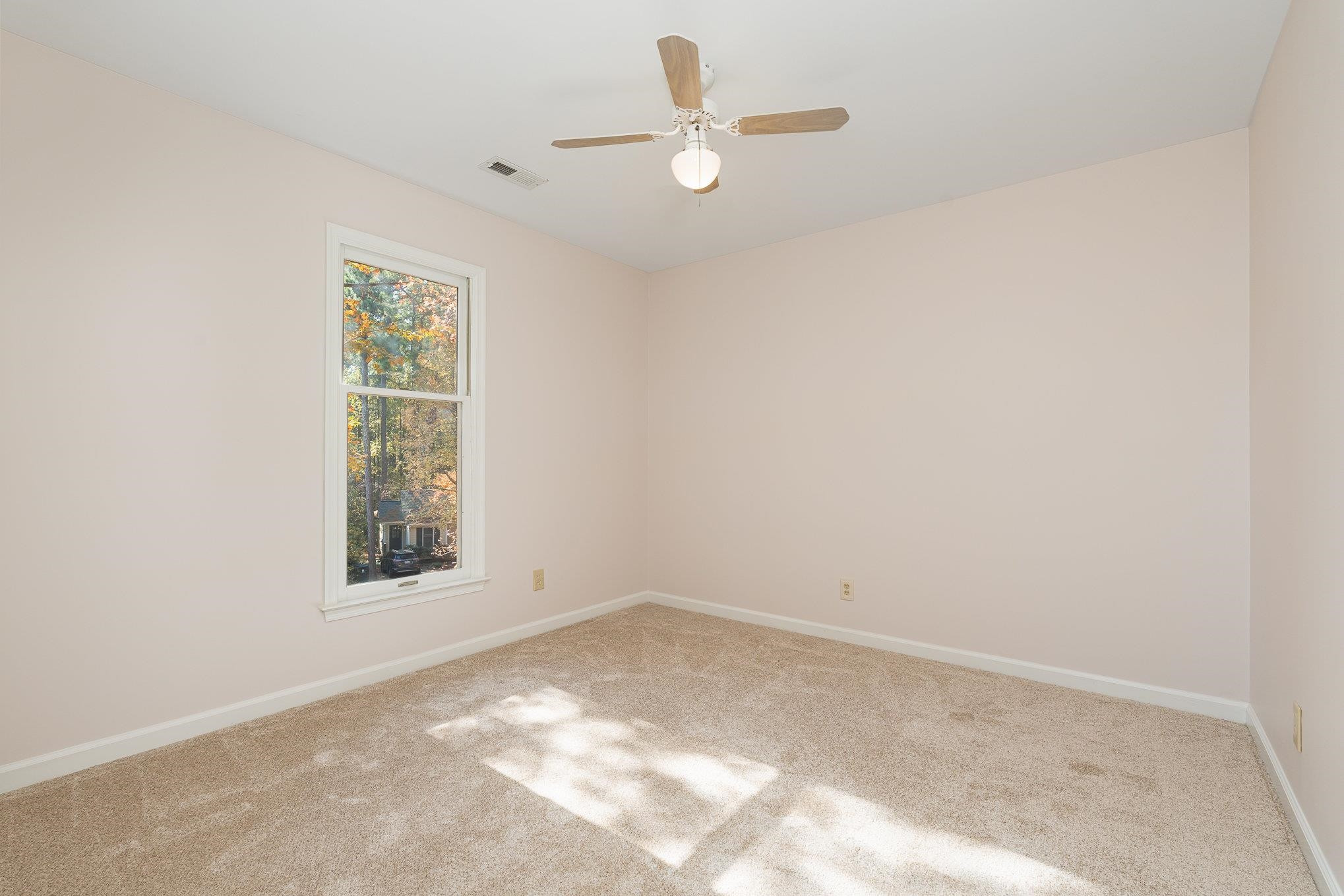 4110 Olde Coach Road Durham, NC 27707 - Photo 14 of 27 an empty room with a window and a fan