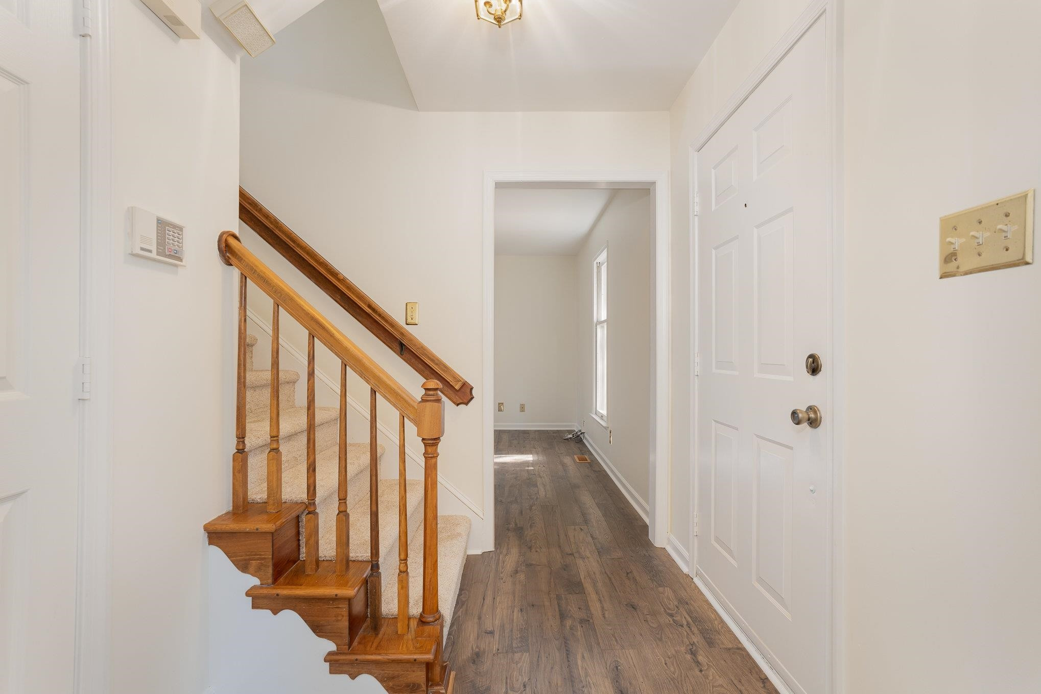 4110 Olde Coach Road Durham, NC 27707 - Photo 3 of 27 a view of a hallway with wooden floor and staircase