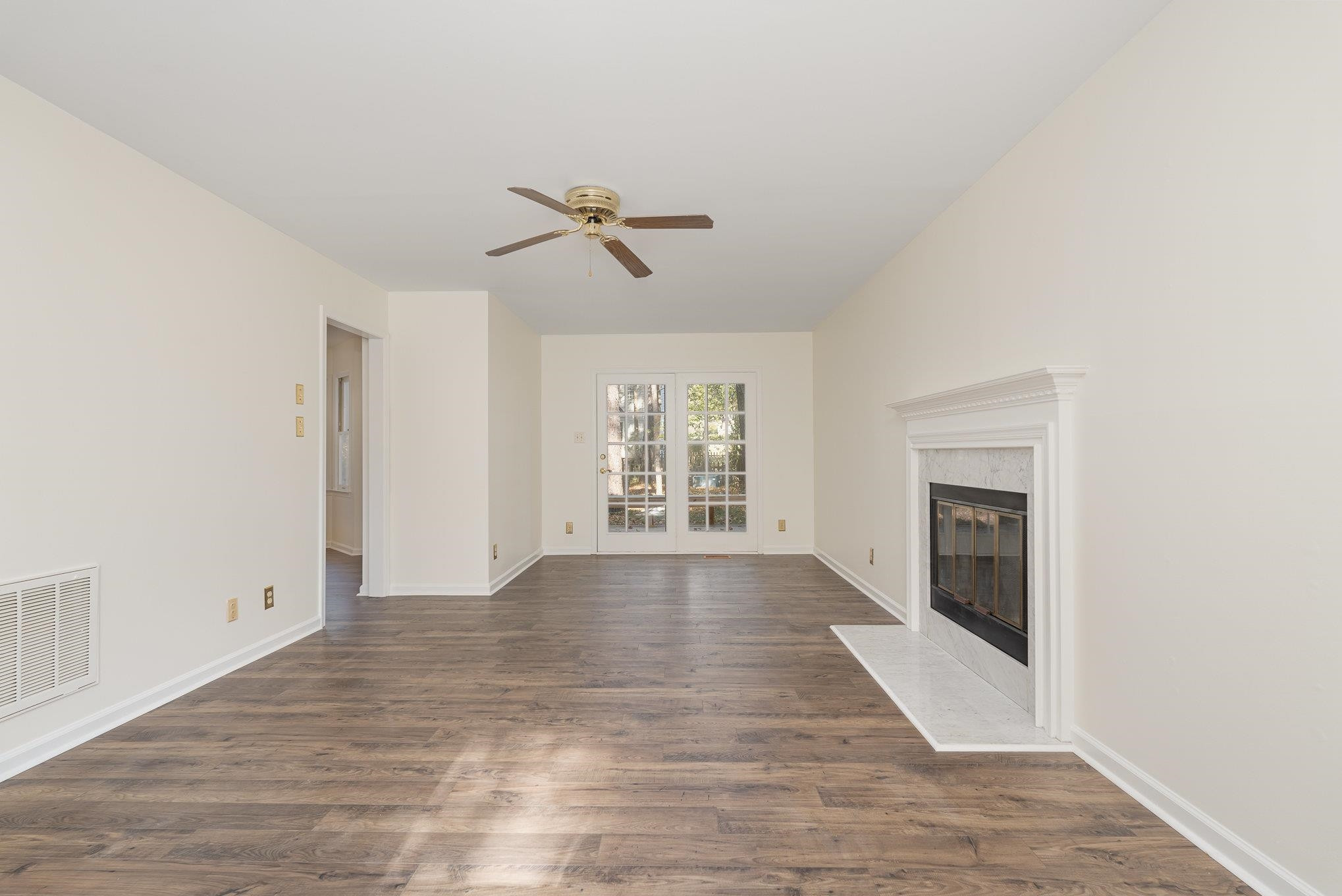 4110 Olde Coach Road Durham, NC 27707 - Photo 5 of 27 a view of empty room with wooden floor and fan