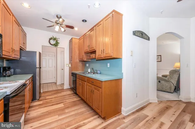 a kitchen with stainless steel appliances granite countertop a stove a refrigerator and a wooden cabinets