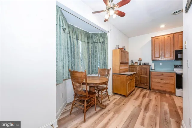 a kitchen with a table chairs and a microwave