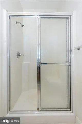 a bathroom with a glass shower door