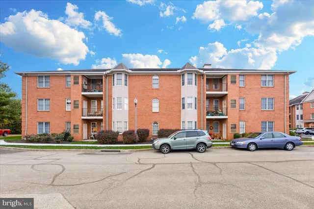 a cars parked in front of brick building