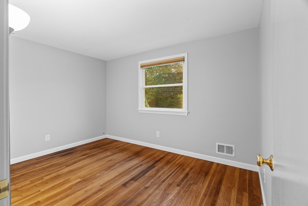 5 Janice Circle Framingham, MA 01701 - Photo 17 of 36 a view of a room with wooden floor and a window