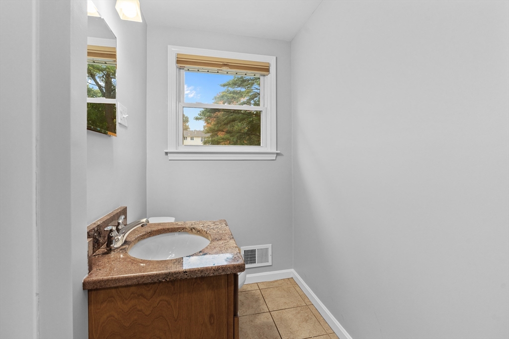5 Janice Circle Framingham, MA 01701 - Photo 19 of 36 a bathroom with a sink and a mirror