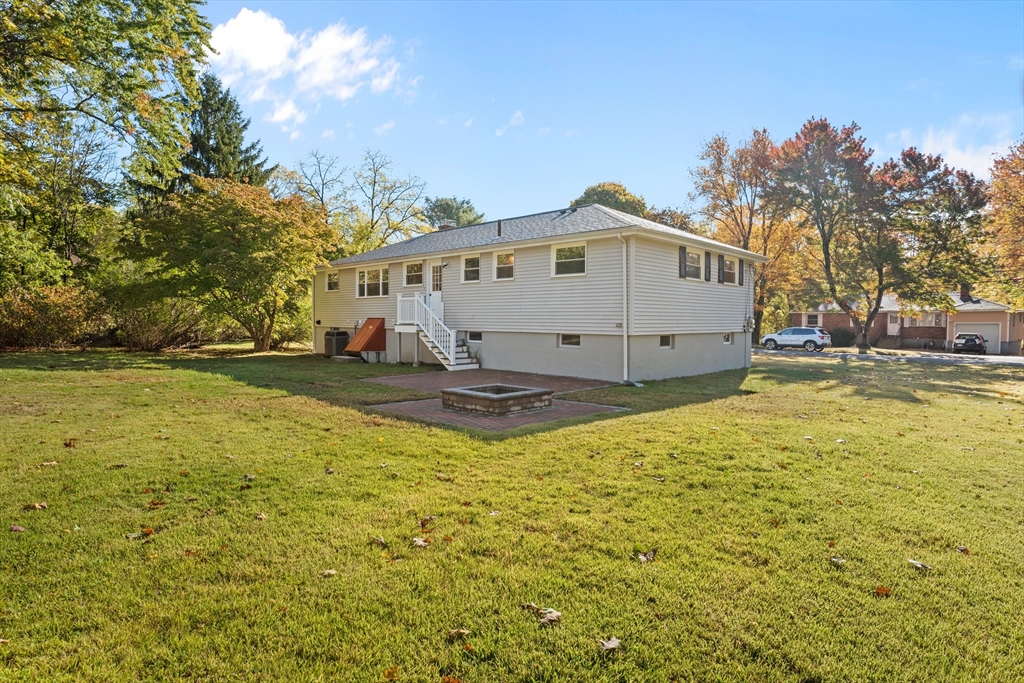 5 Janice Circle Framingham, MA 01701 - Photo 26 of 36 a view of a white house with a large tree and yard