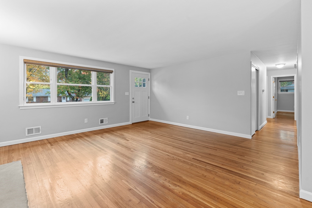 5 Janice Circle Framingham, MA 01701 - Photo 7 of 36 a view of empty room with wooden floor and fan