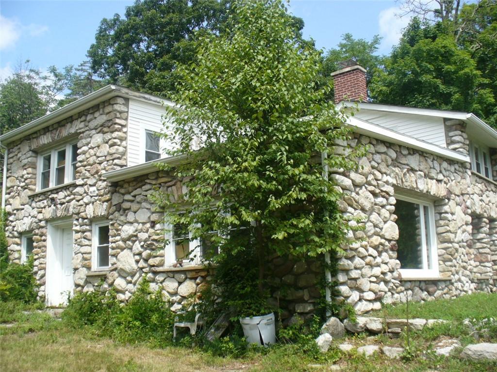 a aerial view of a house with a yard and potted plants