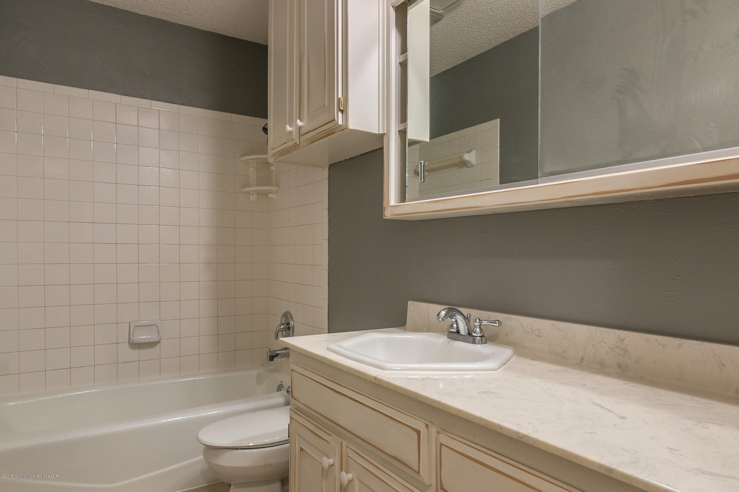 4200 Relatta Avenue Amarillo, TX 79110 - Photo 14 of 18 a bathroom with a granite countertop sink a toilet and bathtub