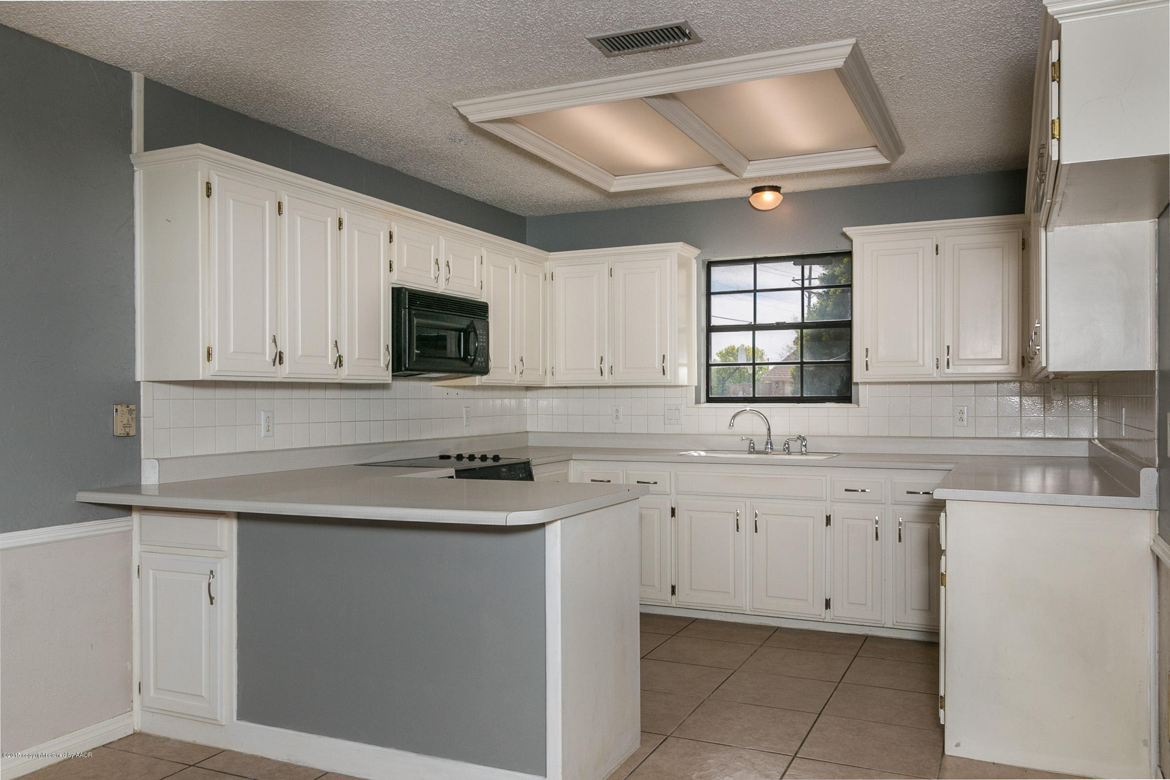 4200 Relatta Avenue Amarillo, TX 79110 - Photo 3 of 18 a kitchen with cabinets appliances a sink and a window