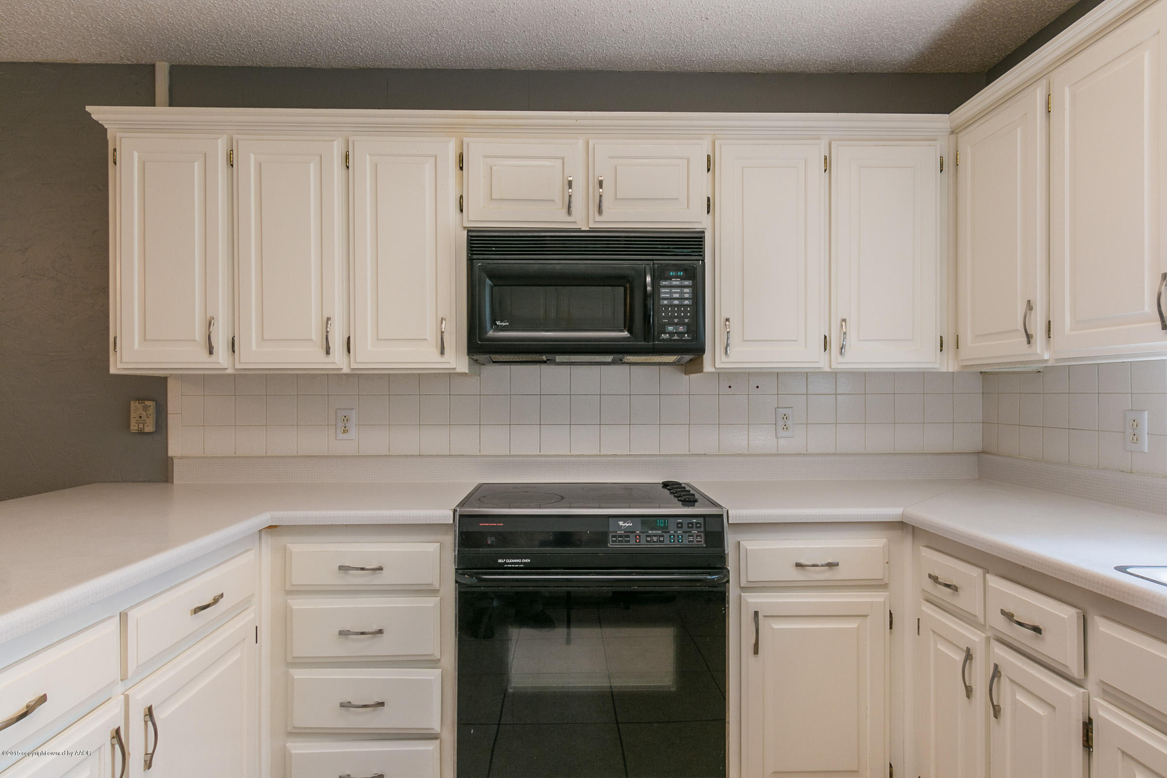 4200 Relatta Avenue Amarillo, TX 79110 - Photo 8 of 18 a kitchen with granite countertop white cabinets and stainless steel appliances
