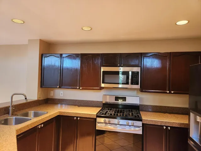 a kitchen with a sink and a stove top oven