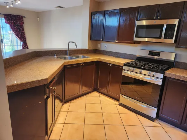 a kitchen with a sink stove and microwave