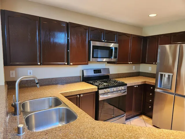 an empty room with windows and fireplace