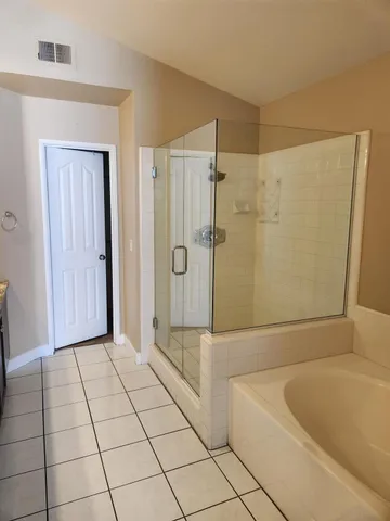 a bathroom with a bathtub and shower