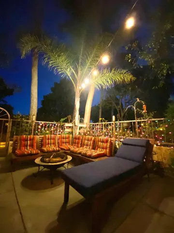 a swimming pool with outdoor seating and yard