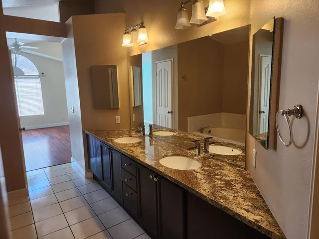a bathroom with a double vanity sink a mirror and a shower
