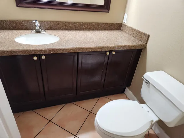 a bathroom with a sink a toilet and vanity