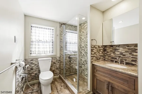a bathroom with a toilet sink and shower