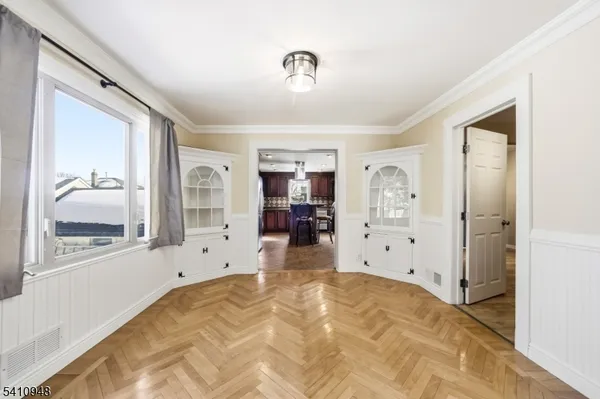 a view of a livingroom with wooden floor and a window