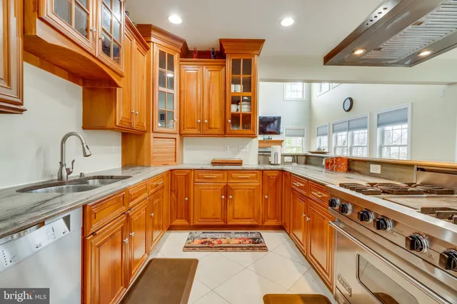 a kitchen with stainless steel appliances granite countertop a stove and a sink