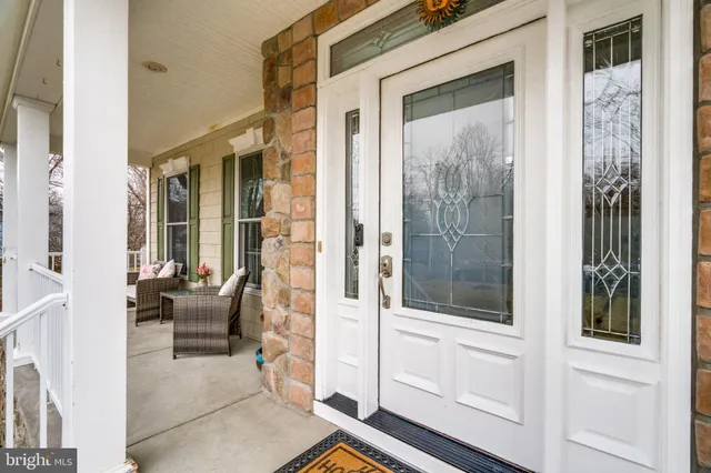 a balcony with furniture and large windows