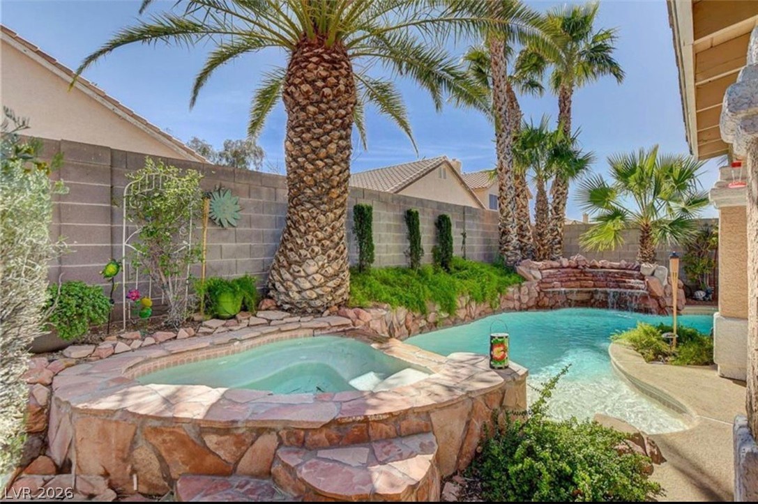 6429 Winding Ridge Las Vegas, NV 89156 - Photo 21 of 22 An oasis awaits with this private backyard pool and spa, surrounded by lush tropical landscaping.