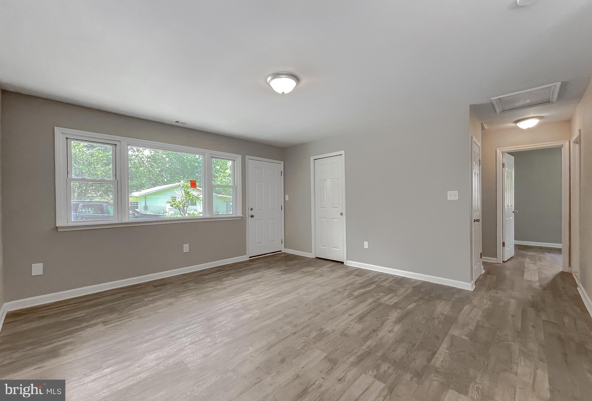 1607 Beech Road St. Leonard, MD 20685 - Photo 12 of 33 an empty room with wooden floor and windows
