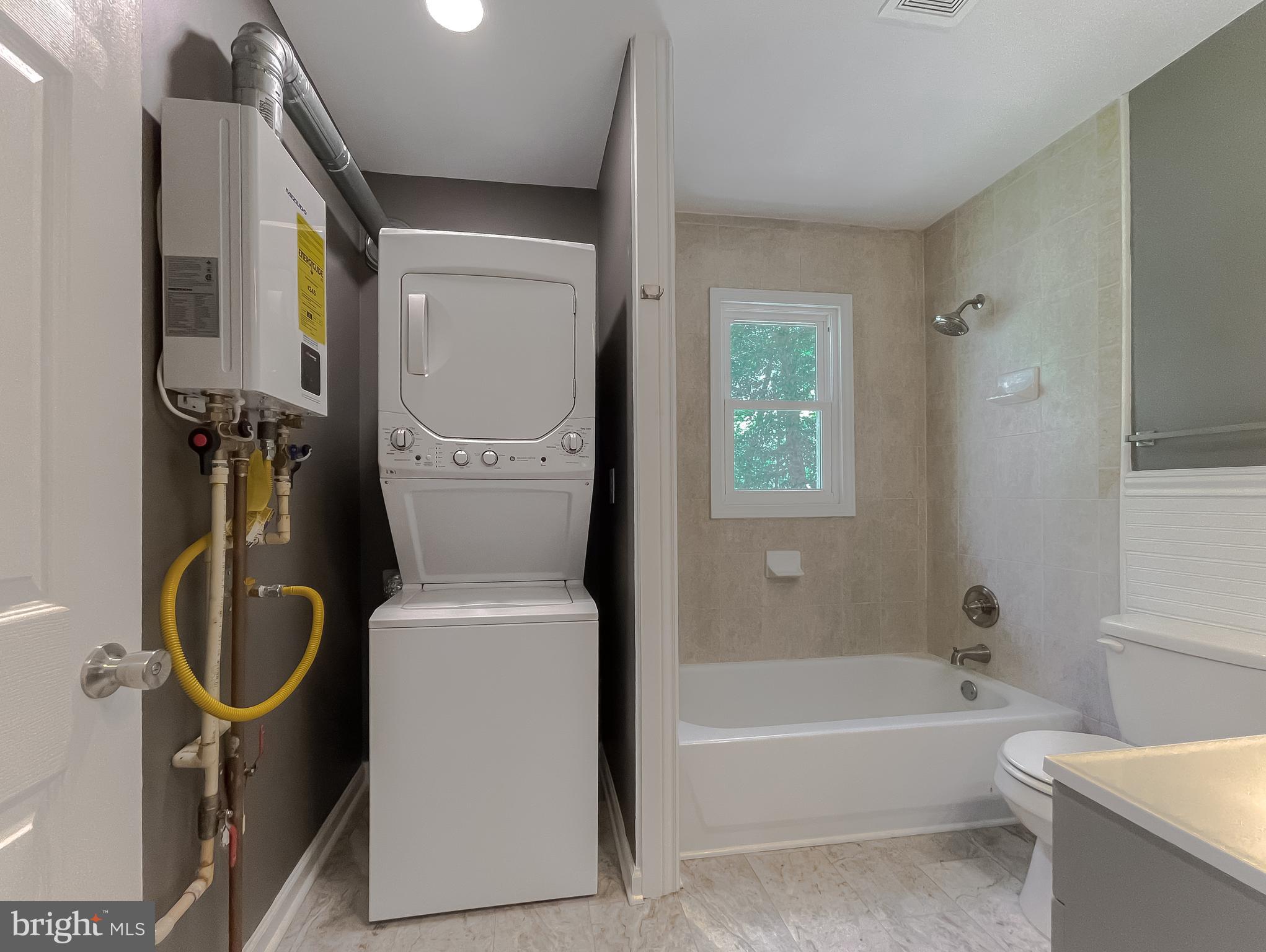 1607 Beech Road St. Leonard, MD 20685 - Photo 26 of 33 a bathroom with a toilet a sink and bathtub